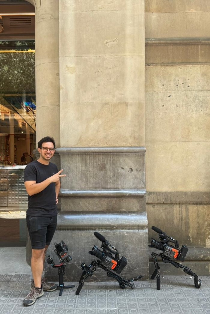 Crew member with camera gimbals on a city street