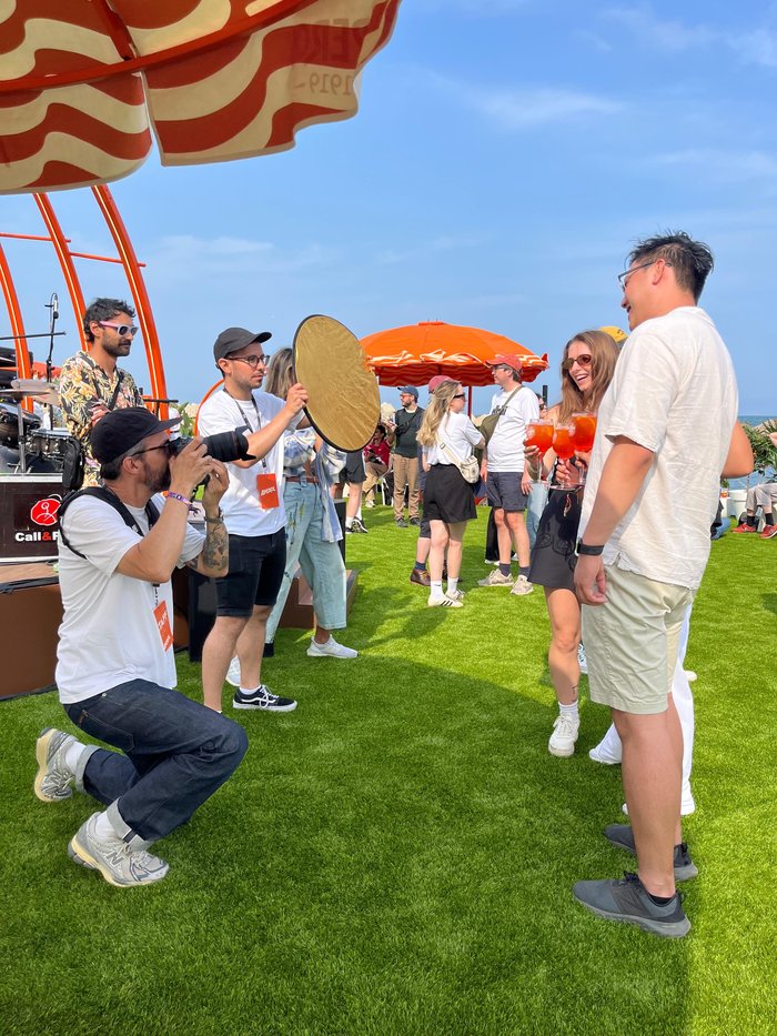 Photographer capturing a moment among guests at an outdoor event
