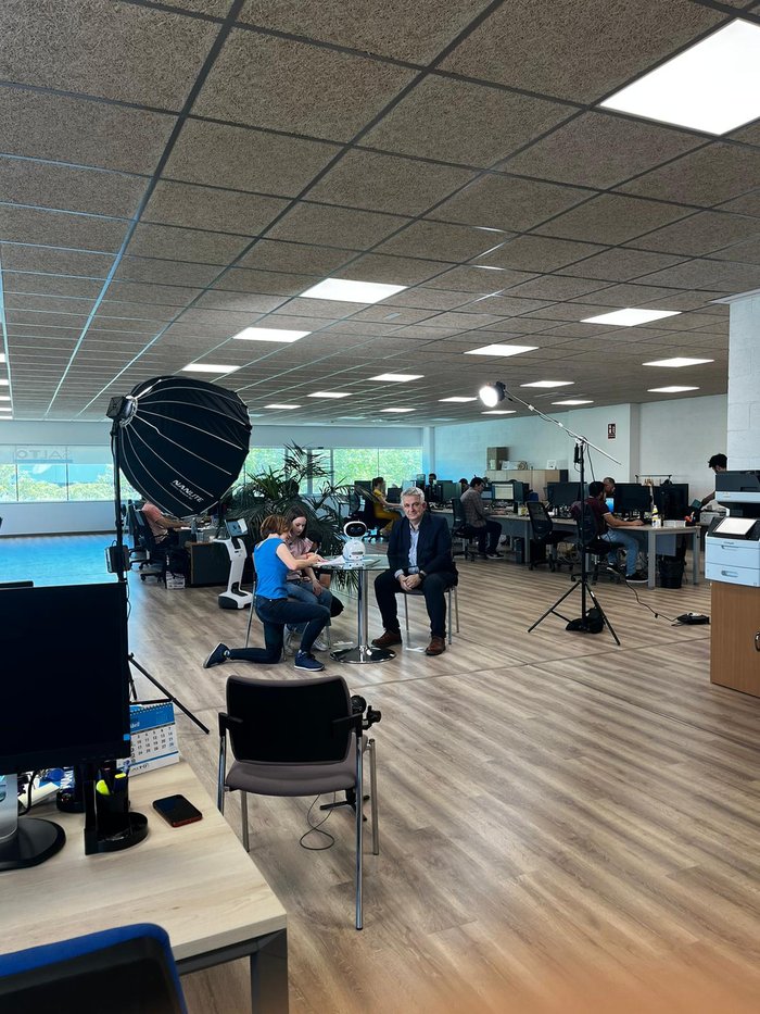 Crew filming an interview in an open-plan office space